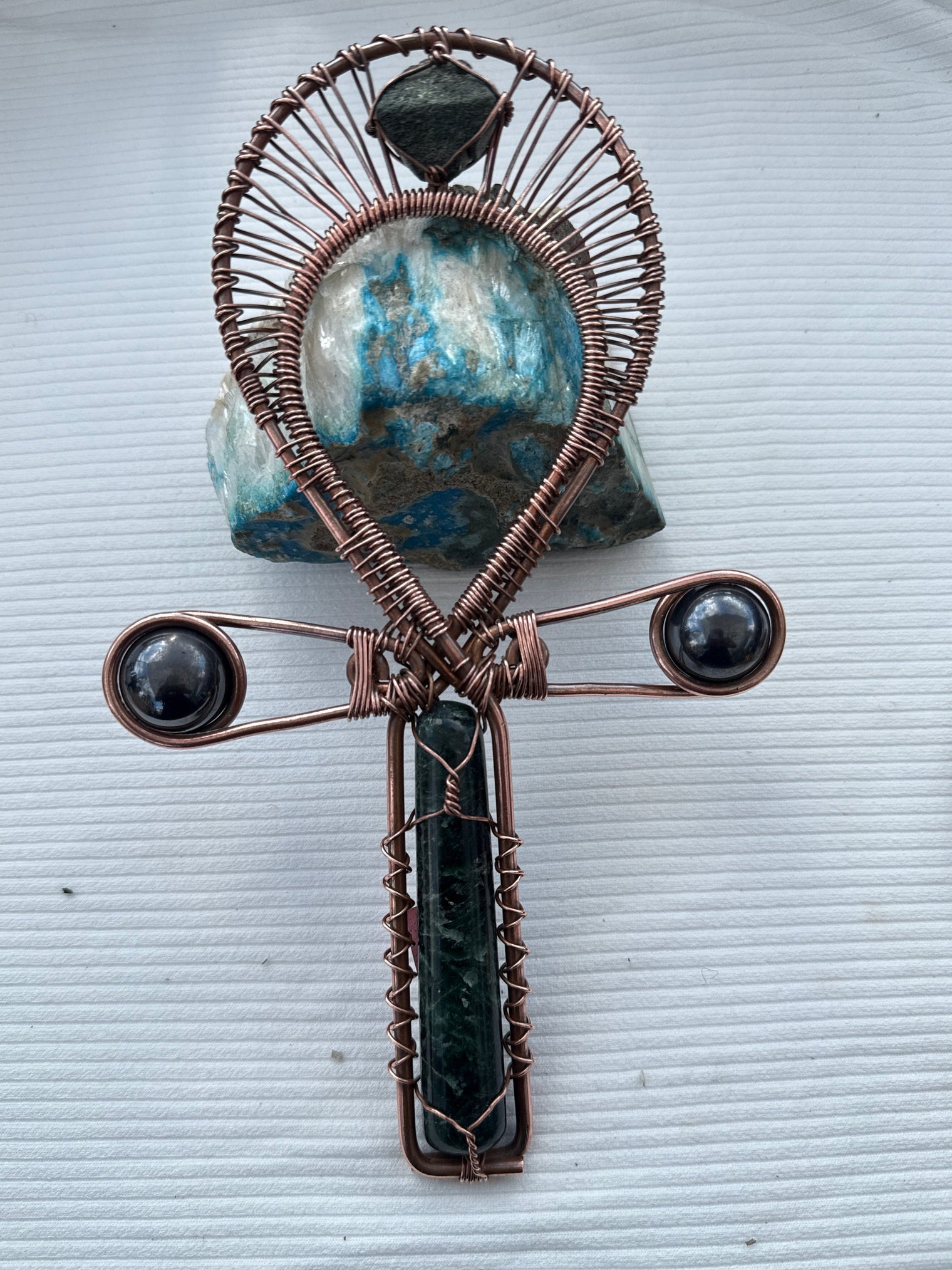 green kyanite and epidote copper wire wrapped ankh with magnetic hematite