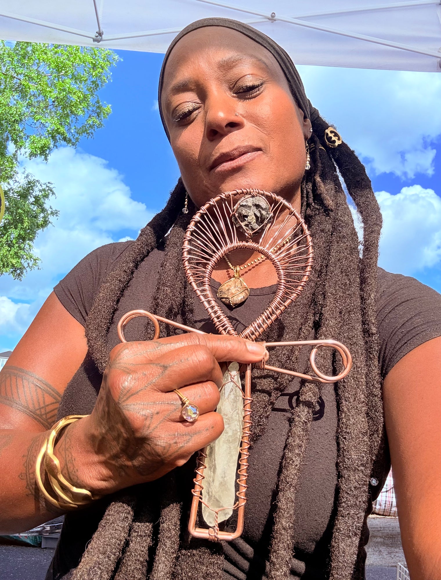 Green quartz and epidote copper ankh being held by Sista Carla