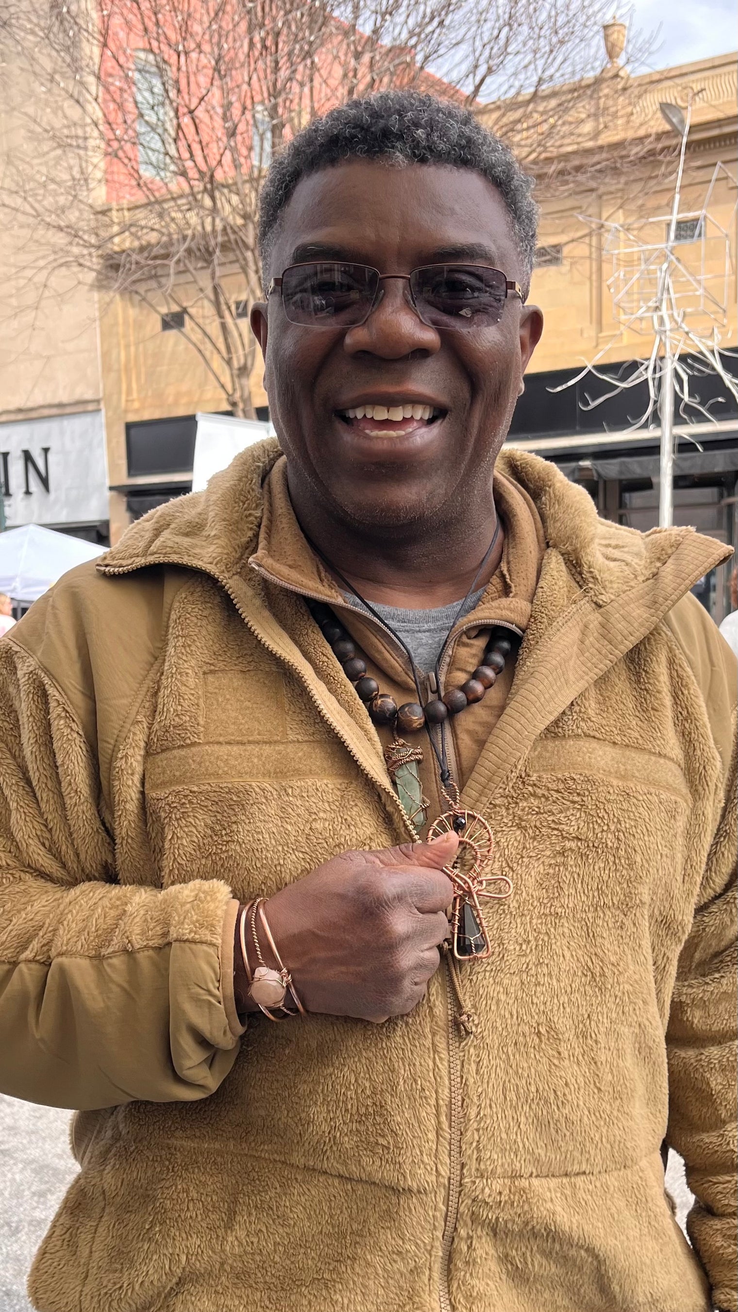 pink beta quartz bracelet modeled by man wearing brown jacket
