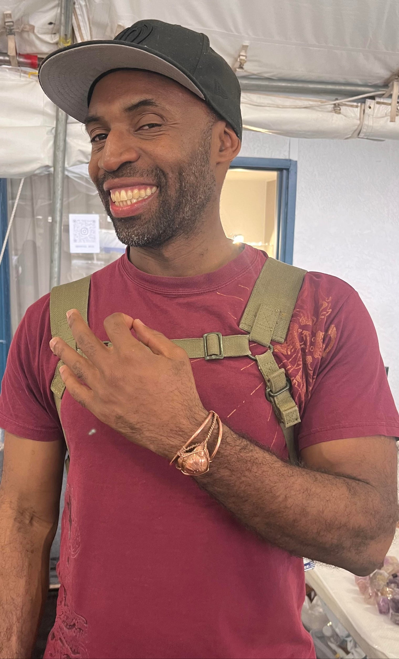 man modeling copper wire wrapped bracetet