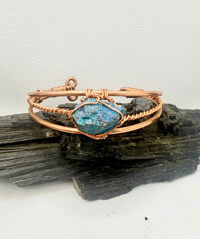 chalcopyrite on copper wirewrapped bracelet on black tourmaline with white background
