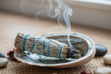 sage 4 inch smudge stick blue wrap burning in shell